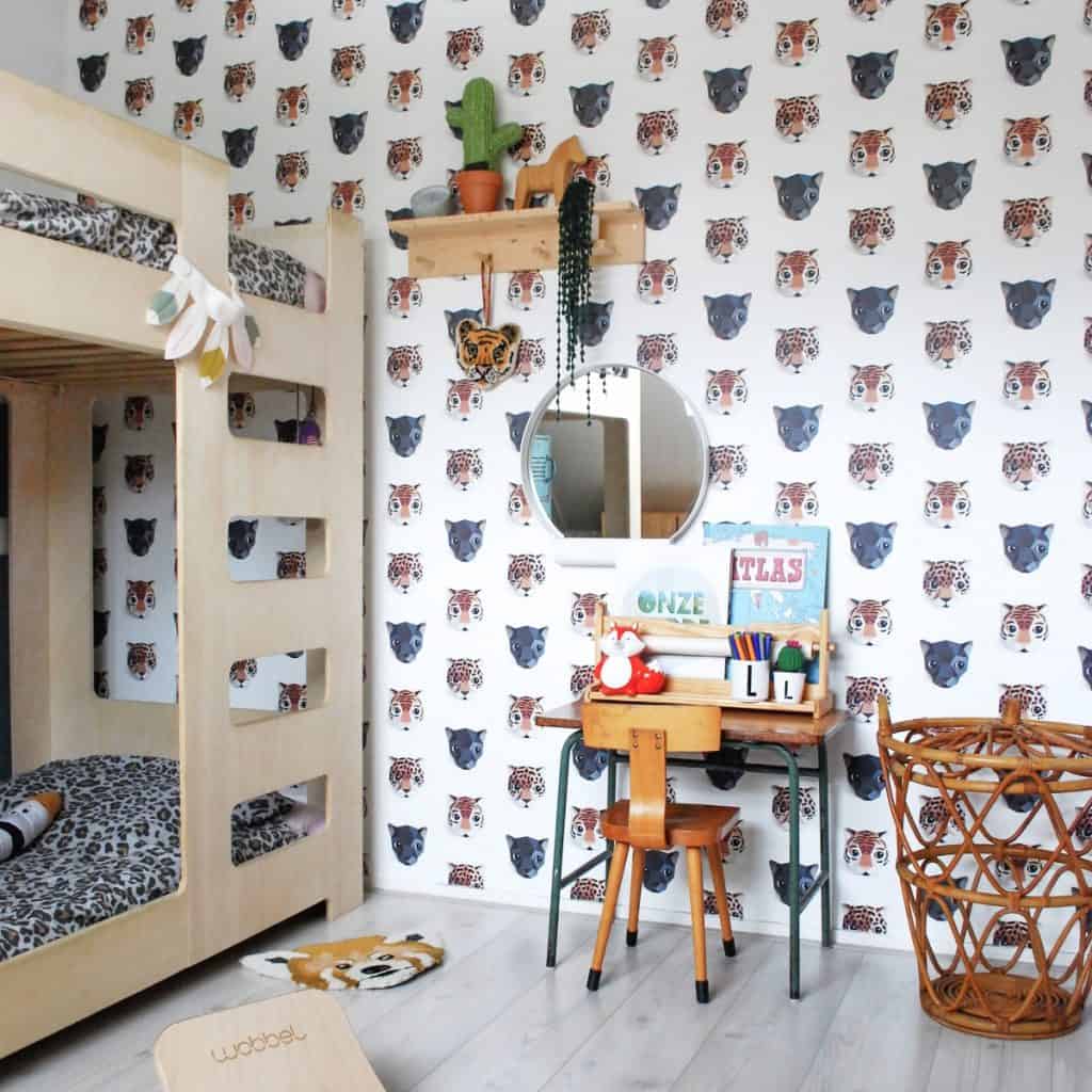 Tapet Panthera intr-o camera cu pat etajat, un birou cu scaun si obiecte de scris, cu oglonda pe perete si o polita cu cactus si obiecte decorative si un cos din ratan pe podea