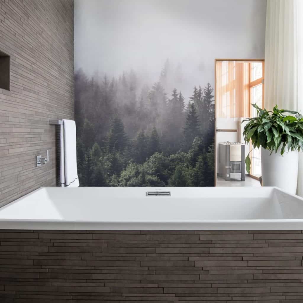 Fototapet 3D Misty Fir Forest intr-o baie cu cada si suport pentru prosop si un vas cu planta decorativa