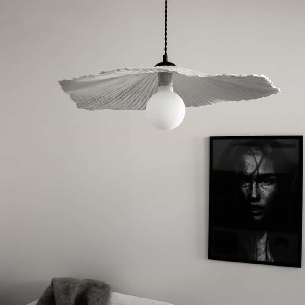 Lampa suspendata Tropez, intr-o camera cu un tablou alb-negru, cu chipul unei femei