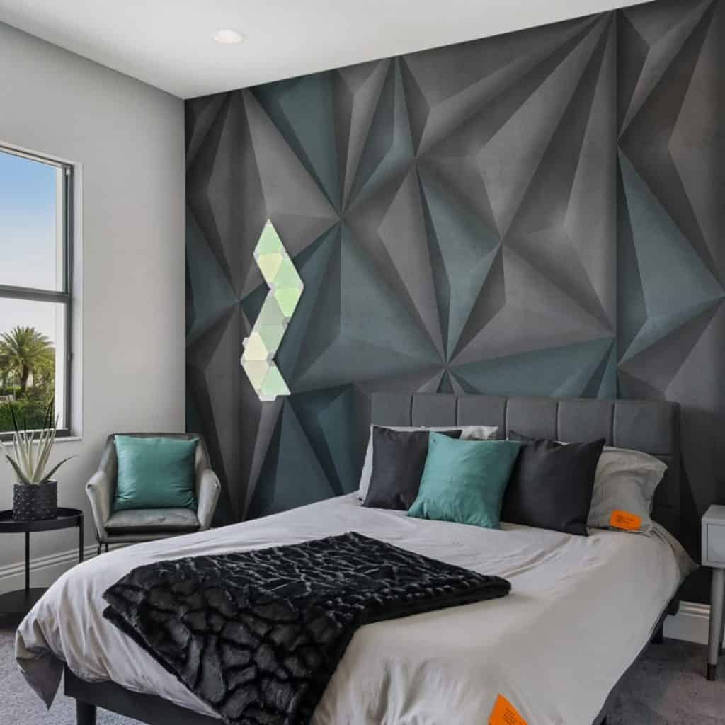 Fototapet Soundproof intr-un dormitor cu pat cu perne decorative si o patura neagra, un fotoliu cu o perna verde si masuta cu planta decorativa in fata unei ferestre