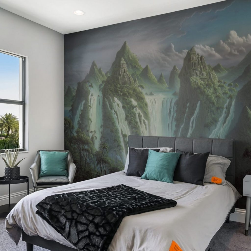 Fototapet Fantasy World, personalizat, Rebel Walls, intr-un dormitor cu pat cu asternuturi si perne decorative colorate, fotoliu gri cu perna verde, masuta neagra cu planta si fereastra