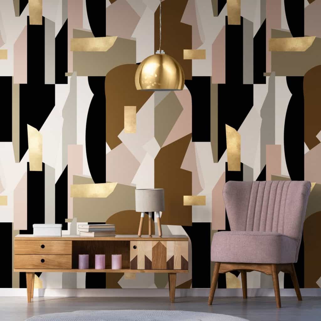 Tapet designer Human Nature, Mindthegap, intr-un living cu lampa suspendata aurie, fotoliu roz si comoda din lemn pe care se afla o lampa si carti